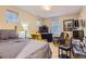 Comfortable bedroom featuring a cozy bed, chairs, and plenty of natural light at 23372 E Chenango Pl, Aurora, CO 80016