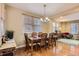 Bright dining room with a classic chandelier, wood table set, and hardwood floors at 23372 E Chenango Pl, Aurora, CO 80016