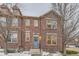 Charming brick townhome featuring a cozy entrance with a blue door and a welcoming wreath at 23372 E Chenango Pl, Aurora, CO 80016