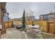 Cozy patio area with seating, a small Christmas tree, and a wooden fence for added privacy at 23372 E Chenango Pl, Aurora, CO 80016