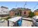 Inviting backyard deck featuring a dining area, string lights, and a relaxing hot tub at 2626 Tennyson St, Denver, CO 80212