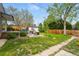 Beautiful backyard with a lush lawn, mature trees, patio and inviting deck, great for relaxing at 2626 Tennyson St, Denver, CO 80212