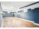 Spacious finished basement with luxury vinyl plank flooring, painted blue walls, and recessed lighting at 2626 Tennyson St, Denver, CO 80212