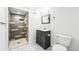 Modern basement bathroom with tiled walk-in shower, gray vanity, and stylish fixtures at 2626 Tennyson St, Denver, CO 80212