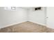 Carpeted basement bedroom offers a cozy space with egress windows, base trim, and neutral walls at 2626 Tennyson St, Denver, CO 80212