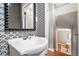 Stylish powder room with unique wallpaper and modern sink at 2626 Tennyson St, Denver, CO 80212