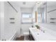 Well-lit bathroom featuring a shower/tub combo, tile flooring, and a decorative mirror at 2626 Tennyson St, Denver, CO 80212