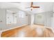Bright, light-filled bedroom featuring wood floors, a ceiling fan, and large windows at 2626 Tennyson St, Denver, CO 80212