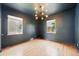 Stylish bedroom with hardwood floors, two windows, and modern light fixture at 2626 Tennyson St, Denver, CO 80212
