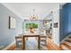 Bright dining room with wood floors, modern lighting, and an open layout to the kitchen at 2626 Tennyson St, Denver, CO 80212