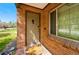 Close-up of a classic front door with brick surround and a decorative window at 2626 Tennyson St, Denver, CO 80212