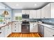 Updated kitchen with stainless steel appliances and ample cabinet space at 2626 Tennyson St, Denver, CO 80212
