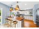 Well-lit kitchen featuring stainless steel appliances and a breakfast bar with seating at 2626 Tennyson St, Denver, CO 80212