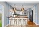 Stylish kitchen island with bar seating and pendant lighting at 2626 Tennyson St, Denver, CO 80212