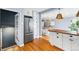 Open kitchen view leading to dining area; features stainless refrigerator at 2626 Tennyson St, Denver, CO 80212