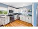 Bright kitchen featuring stainless appliances, granite counters, and ample cabinet space at 2626 Tennyson St, Denver, CO 80212
