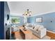 Cozy living room with hardwood floors, a dark accent wall, and a view to front yard at 2626 Tennyson St, Denver, CO 80212
