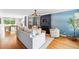 Bright, open living room with hardwood floors, built-in bookshelves, and a modern chandelier at 2626 Tennyson St, Denver, CO 80212