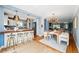 Open concept living space with kitchen island, dining area, and comfortable living room at 2626 Tennyson St, Denver, CO 80212