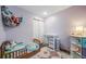 Charming bedroom with wood floor, neutral walls, storage and a crib with soft bedding at 12565 Eudora St, Thornton, CO 80241