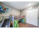 Bright bedroom featuring a bunk bed, closet, wood laminate flooring, and natural light at 12565 Eudora St, Thornton, CO 80241