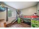Well-lit bedroom featuring a cozy bunk bed, wood laminate flooring, storage and a window at 12565 Eudora St, Thornton, CO 80241