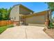 Two-story home featuring an attached two-car garage and mature landscaping at 12565 Eudora St, Thornton, CO 80241
