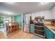 Bright kitchen with stainless steel refrigerator and breakfast table at 12565 Eudora St, Thornton, CO 80241