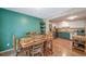 Bright kitchen with stainless steel refrigerator and a wood table at 12565 Eudora St, Thornton, CO 80241