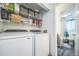 Well-equipped laundry room connecting to the bathroom, with modern washer and dryer appliances and ample storage at 12565 Eudora St, Thornton, CO 80241