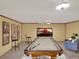 Basement entertainment space includes pool table and seating at 40154 E Colorado Ave, Bennett, CO 80102