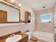 Cozy pink bathroom with a wooden vanity and cabinet at 40154 E Colorado Ave, Bennett, CO 80102