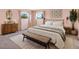 Cozy bedroom with pink walls, neutral furnishings, and bright windows at 40154 E Colorado Ave, Bennett, CO 80102