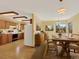 Traditional eat-in kitchen with wood cabinets, wood flooring, and dining area with a large window at 40154 E Colorado Ave, Bennett, CO 80102