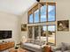 Bright living room boasts lots of natural light with large windows and vaulted ceilings at 40154 E Colorado Ave, Bennett, CO 80102