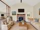 Comfortable living room with a stone fireplace, vaulted ceiling, and views to other living spaces at 40154 E Colorado Ave, Bennett, CO 80102