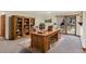 Office with a large wooden desk, bookcase, and a French door that leads to the exterior at 40154 E Colorado Ave, Bennett, CO 80102