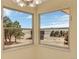 A corner view window displaying a vast, open prairie with trees and outbuildings beneath a blue sky at 40154 E Colorado Ave, Bennett, CO 80102
