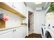 Bright laundry room with upper cabinets, counter space, and modern washer/dryer at 960 Grape St, Denver, CO 80220