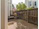 Private backyard with gravel, wood fences, and seating bench; perfect for outdoor gatherings at 1050 S Monaco Pkwy # 126, Denver, CO 80224