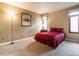 Bedroom featuring neutral walls, carpet flooring, and natural light from a window, offering a cozy space at 1050 S Monaco Pkwy # 126, Denver, CO 80224