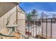 Private balcony featuring iron railings and a cozy table and chair set overlooking the parking at 750 Tabor St # 46, Lakewood, CO 80401