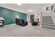 Finished basement with plush carpeting, modern staircase, and cozy seating area at 750 Tabor St # 46, Lakewood, CO 80401