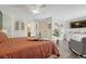Spacious bedroom with wood floors, a cozy chair, and a serene view of the house at 750 Tabor St # 46, Lakewood, CO 80401