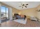 Bedroom featuring natural light from sliding glass door and ceiling fan for added comfort at 750 Tabor St # 46, Lakewood, CO 80401