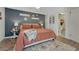 Well-lit bedroom with a decor, an accent wall and an adjoining bathroom at 750 Tabor St # 46, Lakewood, CO 80401