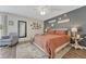 Inviting bedroom with a neutral palette, patterned rug, and accent wall with decor at 750 Tabor St # 46, Lakewood, CO 80401