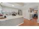 Well-lit kitchen featuring white cabinets, a stainless steel refrigerator, and a center island at 750 Tabor St # 46, Lakewood, CO 80401