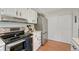 Close-up of kitchen area with stainless steel appliances and white cabinets at 750 Tabor St # 46, Lakewood, CO 80401