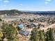 Scenic aerial view of a cozy neighborhood showcasing the serene lake and lush greenery at 508 Viola St, Palmer Lake, CO 80133